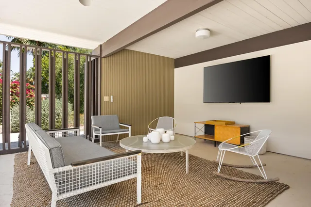 a dining room with furniture and a large window