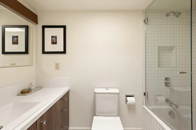 a bedroom with a bed and a potted plant