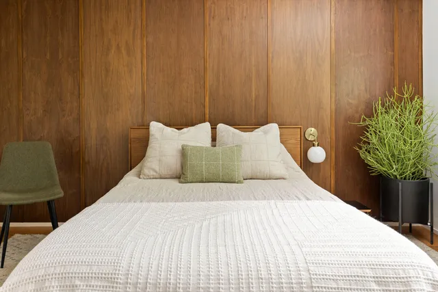 a bedroom with a bed and a table