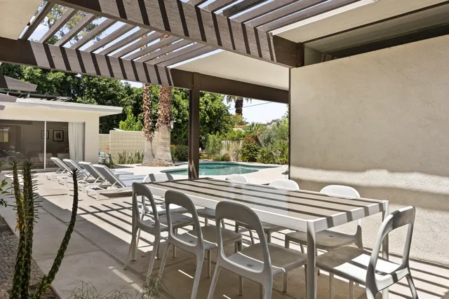 a view of backyard with seating area and trees