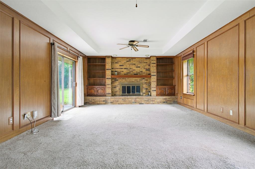 220 Green Ridge Drive Double Oak, TX 75077 - Photo 13 of 25 Your den provides plenty of storage for the book lover and another fireplace for those cool winter evenings.