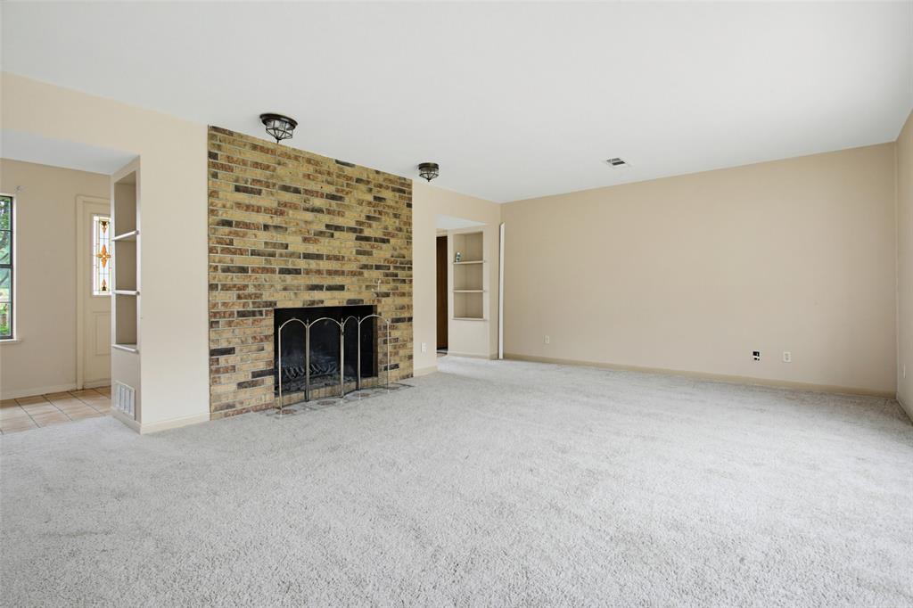 220 Green Ridge Drive Double Oak, TX 75077 - Photo 5 of 25 The formal living area with fireplace is ideal for entertaining or simply evenings with the family.