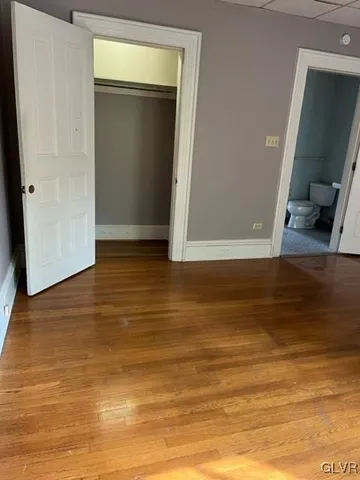 a view of a room with wooden floor