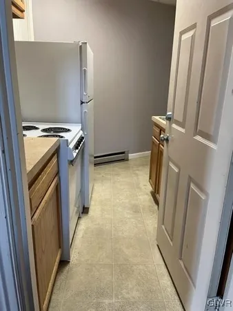 a view of a storage and utility room with washer and dryer