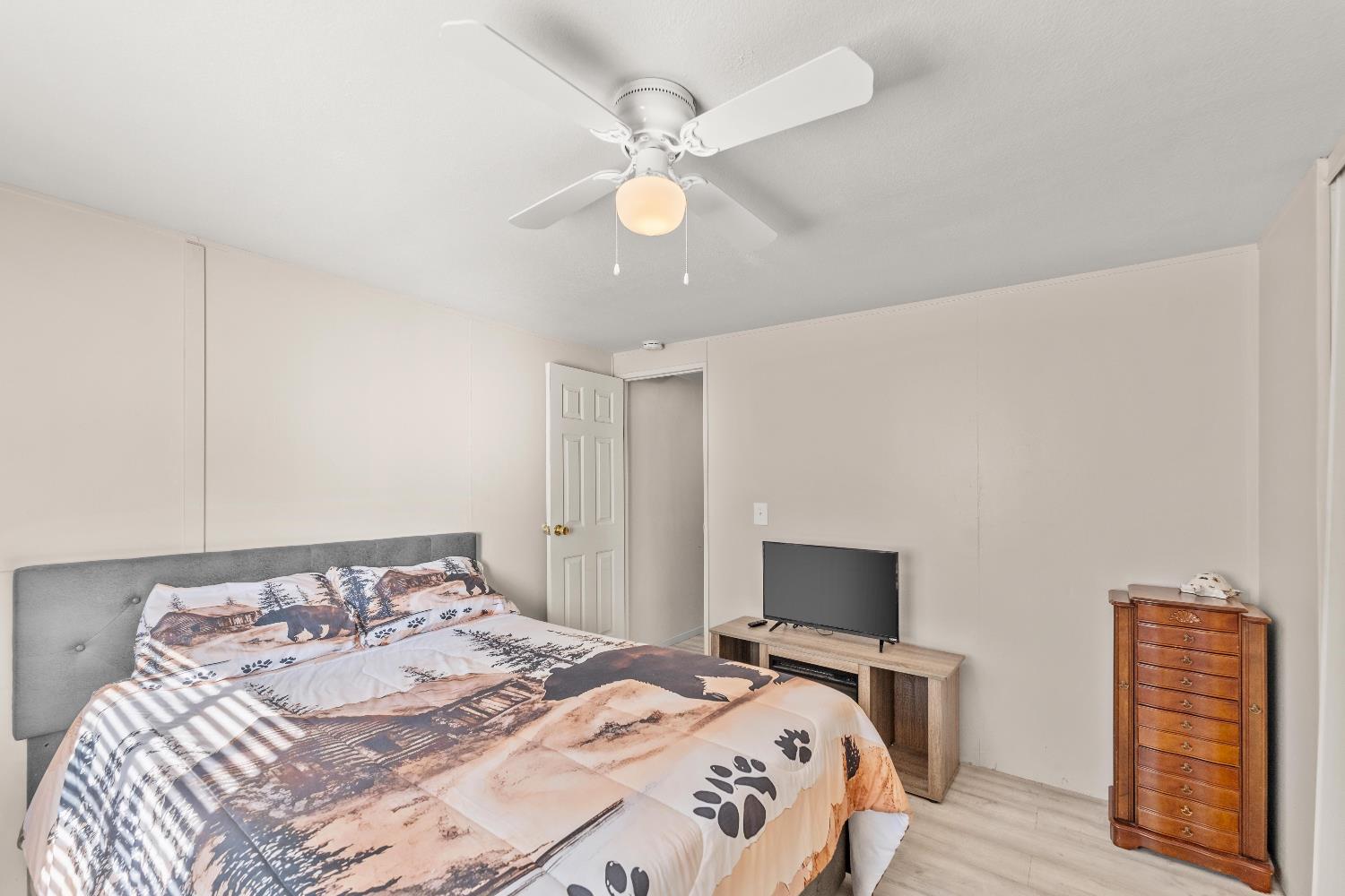 135 Ponderosa Way, Unit 2 Colfax, CA 95713 - Photo 17 of 33 a bedroom with a bed and a chandelier