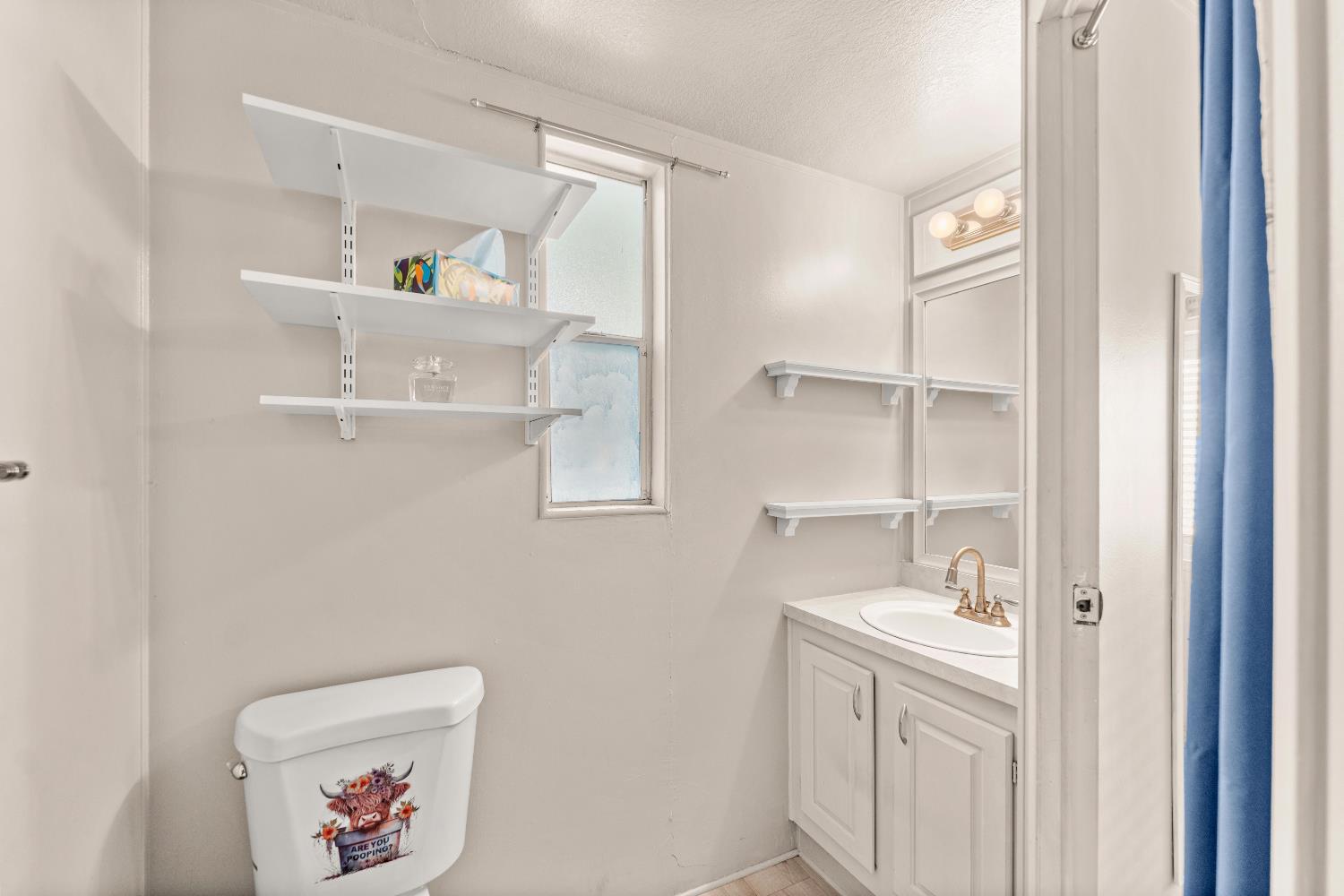 135 Ponderosa Way, Unit 2 Colfax, CA 95713 - Photo 24 of 33 a bathroom with a double vanity sink and a window