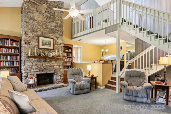 a living room with furniture a fireplace and a book shelf