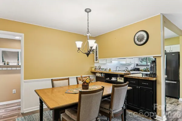 a kitchen with stainless steel appliances granite countertop a refrigerator stove and sink