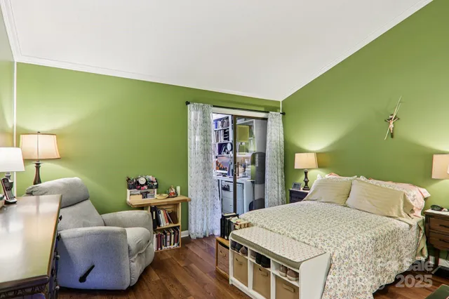 a bedroom with a bed and a lamp