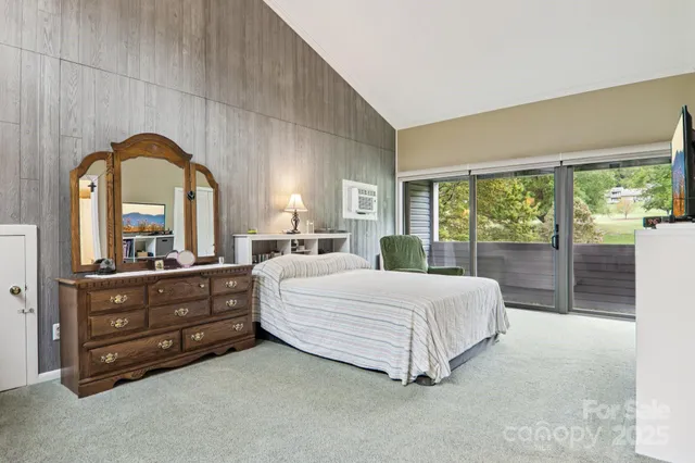 a living room with furniture a flat screen tv and a large window