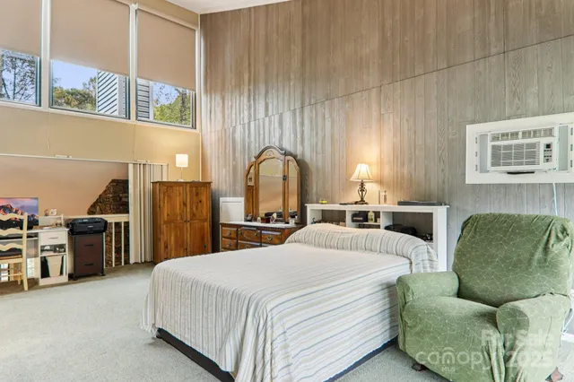 a bed room with a bed and a chair