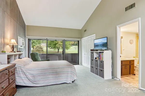 a bed room with a bed and a chair