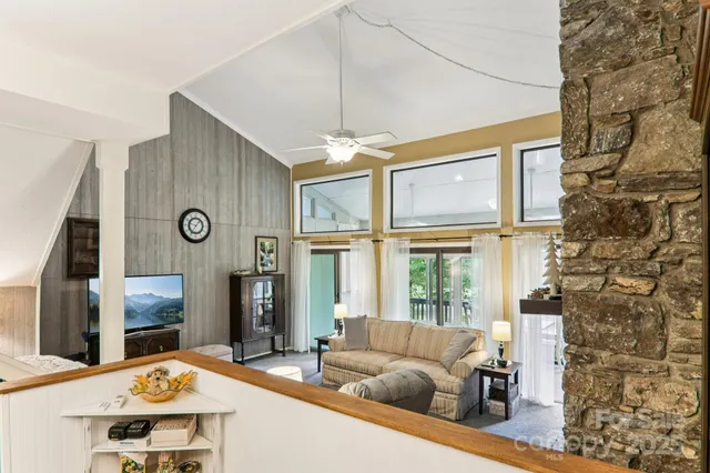 a living room with fireplace furniture and a flat screen tv