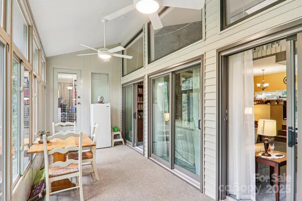 a view of a dining room with furniture large windows and wooden floor