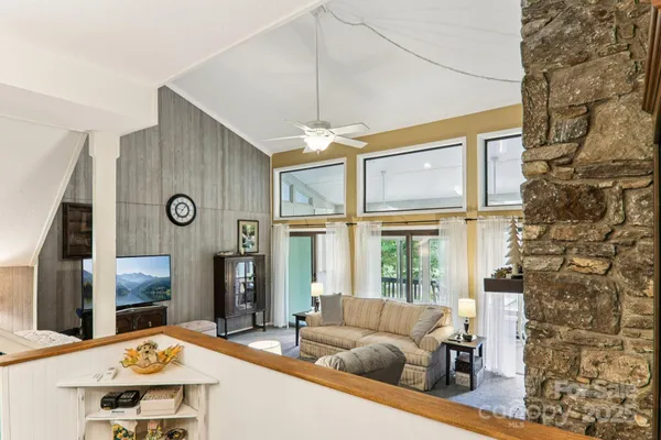 a living room with fireplace furniture and a flat screen tv