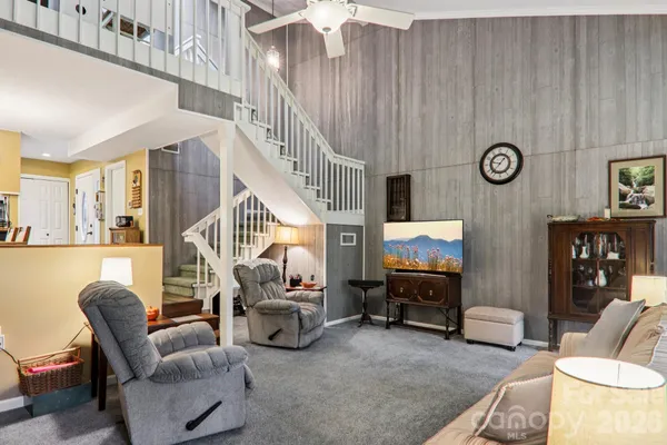 a living room with furniture a fireplace and a book shelf