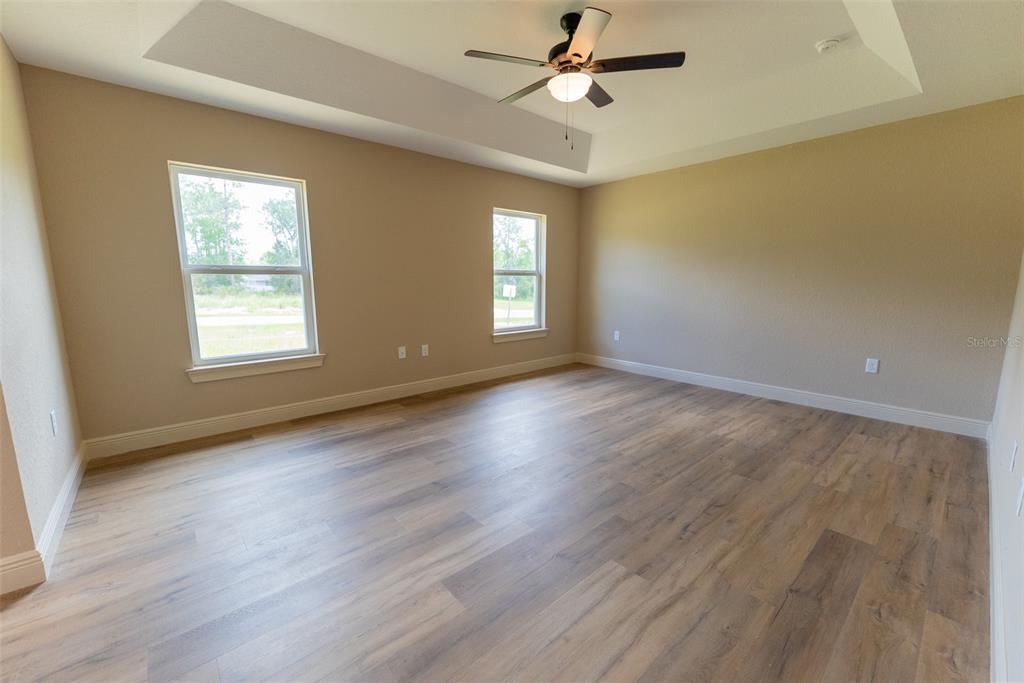 579 Northwest Ridgewood Road Dunnellon, FL 34431 - Photo 22 of 58 a view of an empty room with wooden floor and a window