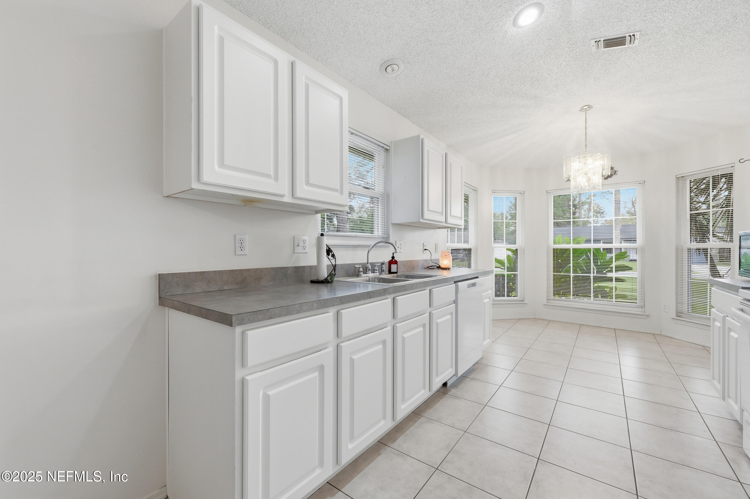 1828 Killarn Circle Middleburg, FL 32068 - Photo 17 of 28 a kitchen with stainless steel appliances granite countertop a sink and a white cabinets