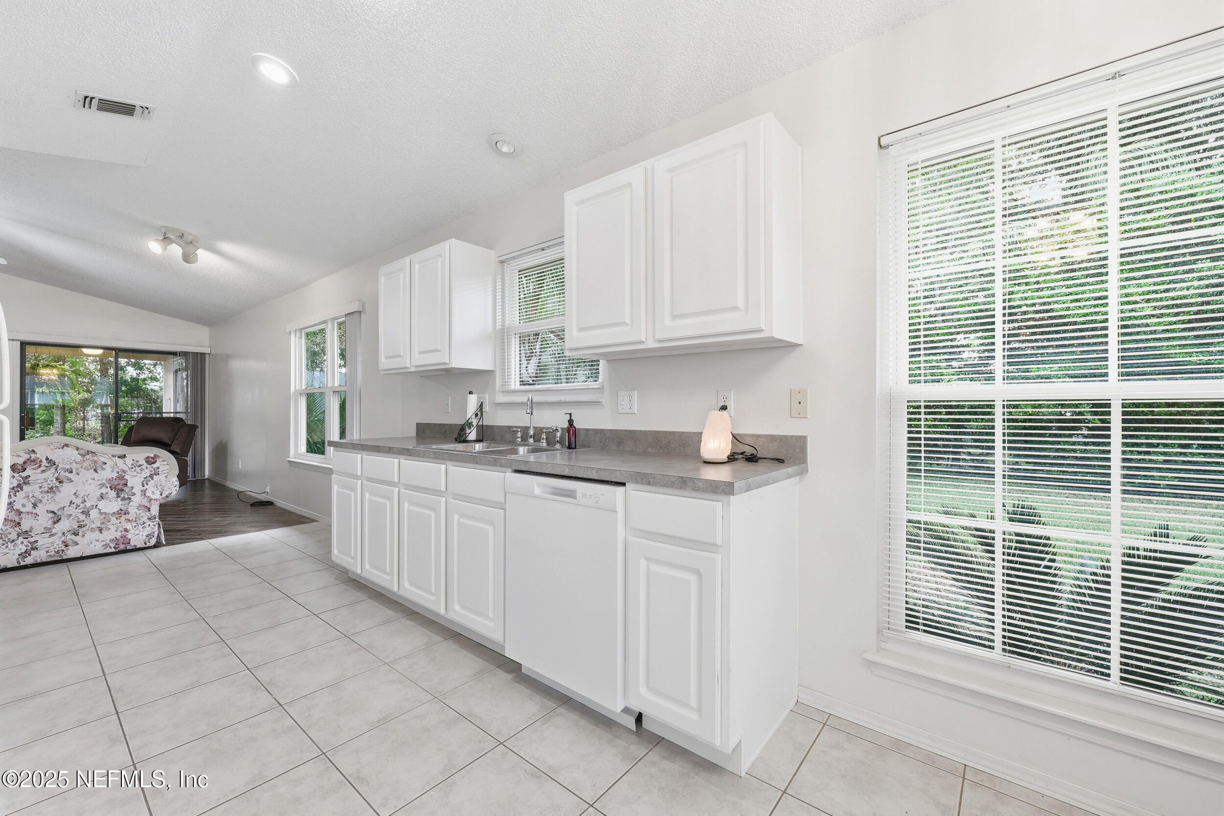 1828 Killarn Circle Middleburg, FL 32068 - Photo 18 of 28 a kitchen with stainless steel appliances granite countertop a stove a sink and a refrigerator