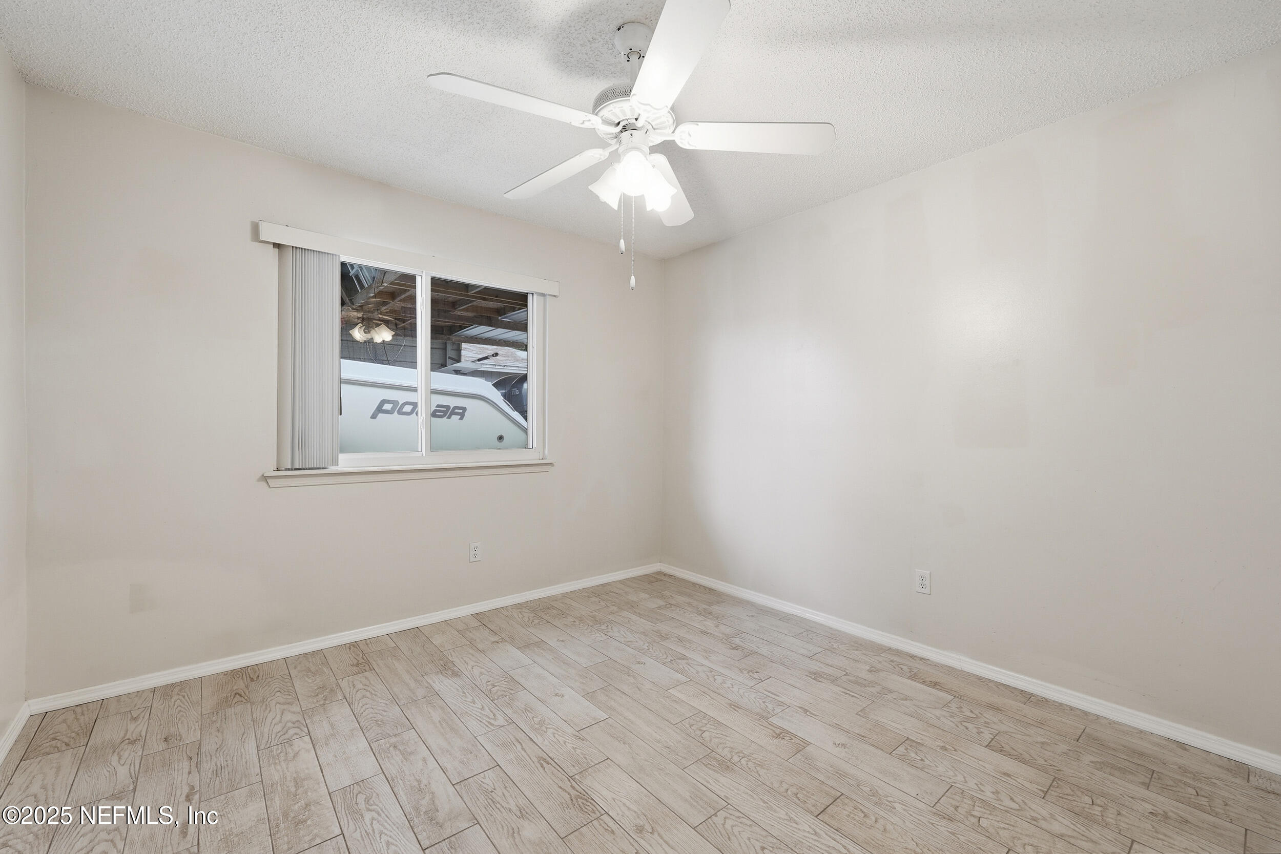 1828 Killarn Circle Middleburg, FL 32068 - Photo 27 of 28 an empty room with wooden floor and ceiling fan