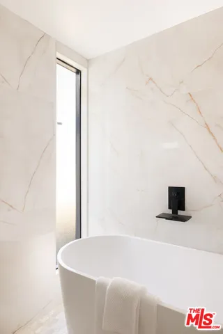 a white bath tub sitting in a bathroom