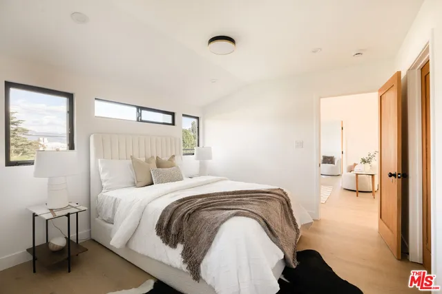 a bedroom with a bed and a chandelier