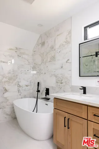 a bathroom with a bathtub and a sink