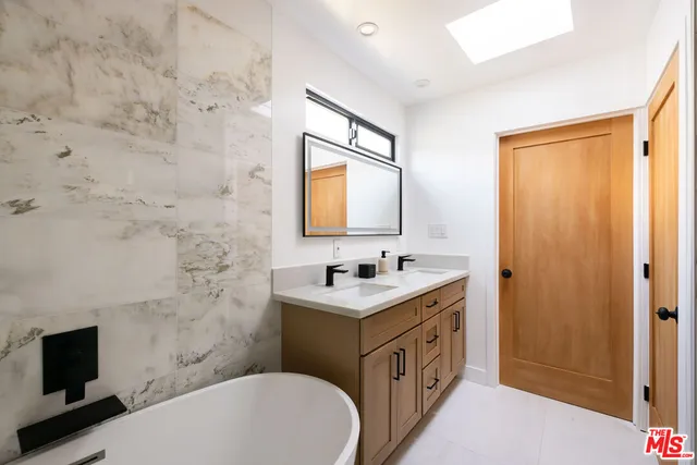 a bathroom with a sink a toilet and mirror