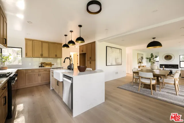 a kitchen with cabinets a sink and appliances