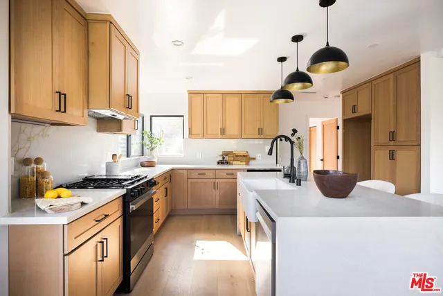 a kitchen with a sink a stove and a window