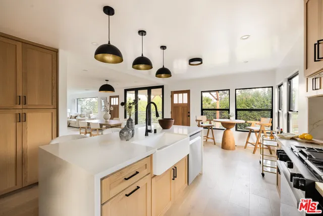a large kitchen with a large window and furniture