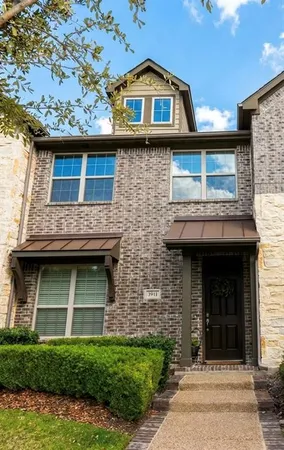a view of a brick house with large windows