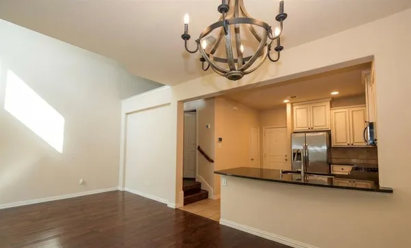 a view of a room with wooden floor