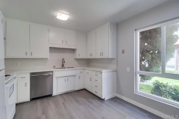 a kitchen with sink cabinets and wooden floor