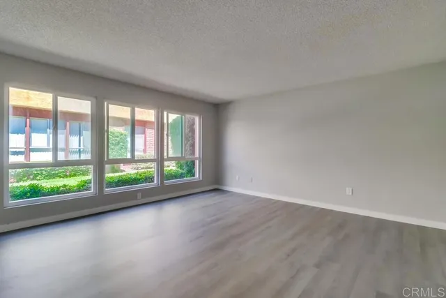 a view of room with window and wooden floor