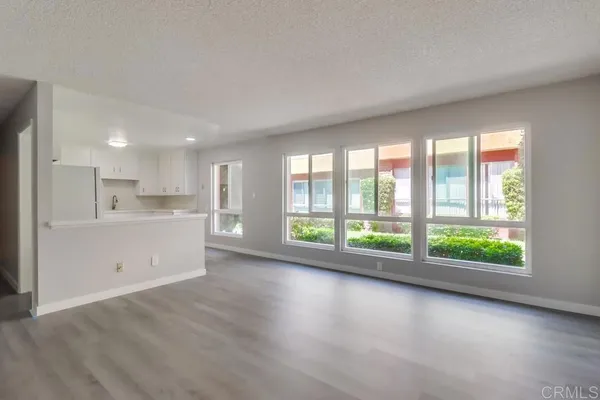 a view of a kitchen with large windows