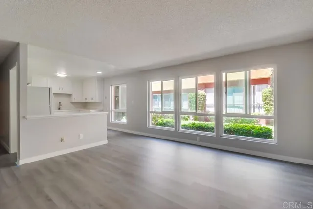 a view of a kitchen with large windows