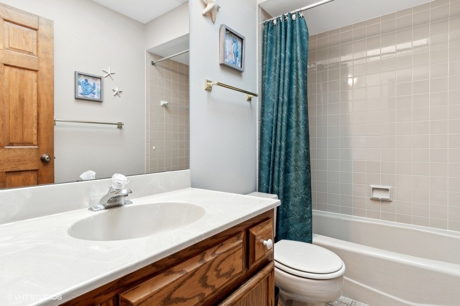 809 Hyde Park Lane Naperville, IL 60565 - Photo 17 of 30 a bathroom with a sink toilet vanity and shower