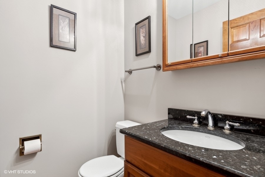 809 Hyde Park Lane Naperville, IL 60565 - Photo 22 of 30 a bathroom with a granite countertop toilet sink and mirror