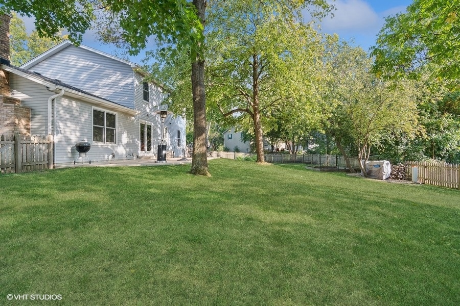 809 Hyde Park Lane Naperville, IL 60565 - Photo 26 of 30 a front view of a house with a garden