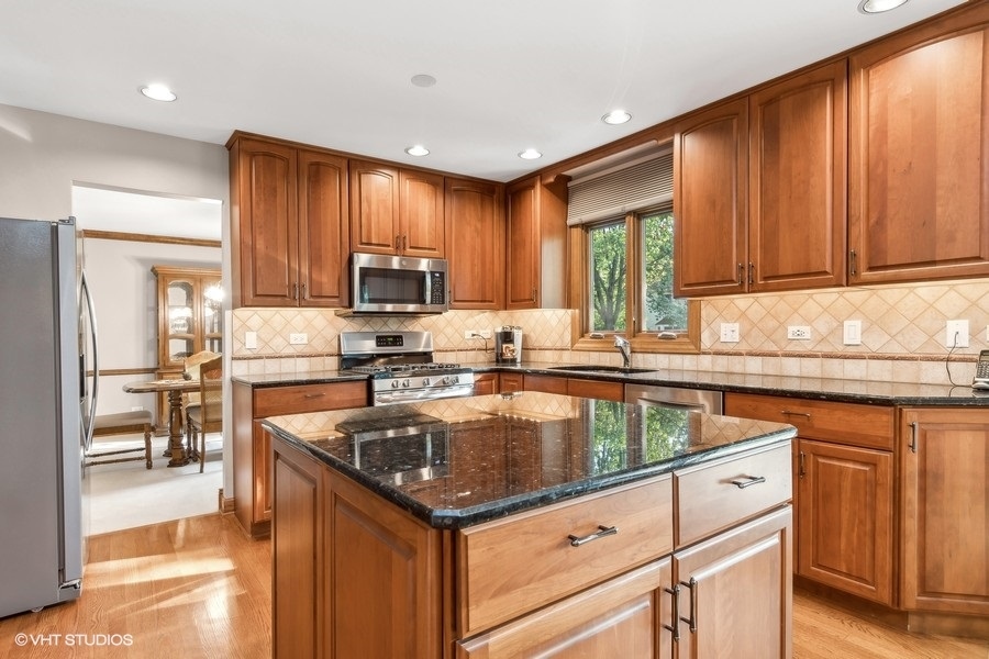 809 Hyde Park Lane Naperville, IL 60565 - Photo 5 of 30 a kitchen with a sink stove and cabinets