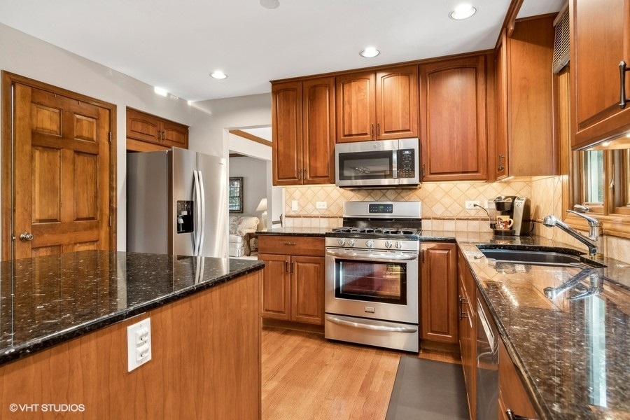 809 Hyde Park Lane Naperville, IL 60565 - Photo 6 of 30 a kitchen with stainless steel appliances granite countertop a refrigerator a stove top oven a sink and dishwasher