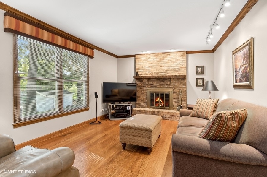 809 Hyde Park Lane Naperville, IL 60565 - Photo 10 of 30 a living room with furniture a large window and a flat screen tv