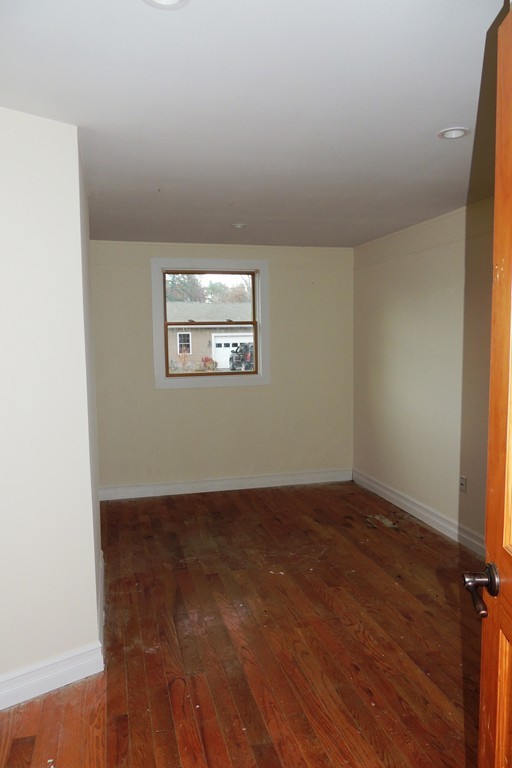 763 Bradley Road Springfield, MA 01109 - Photo 10 of 14 an empty room with wooden floor and windows