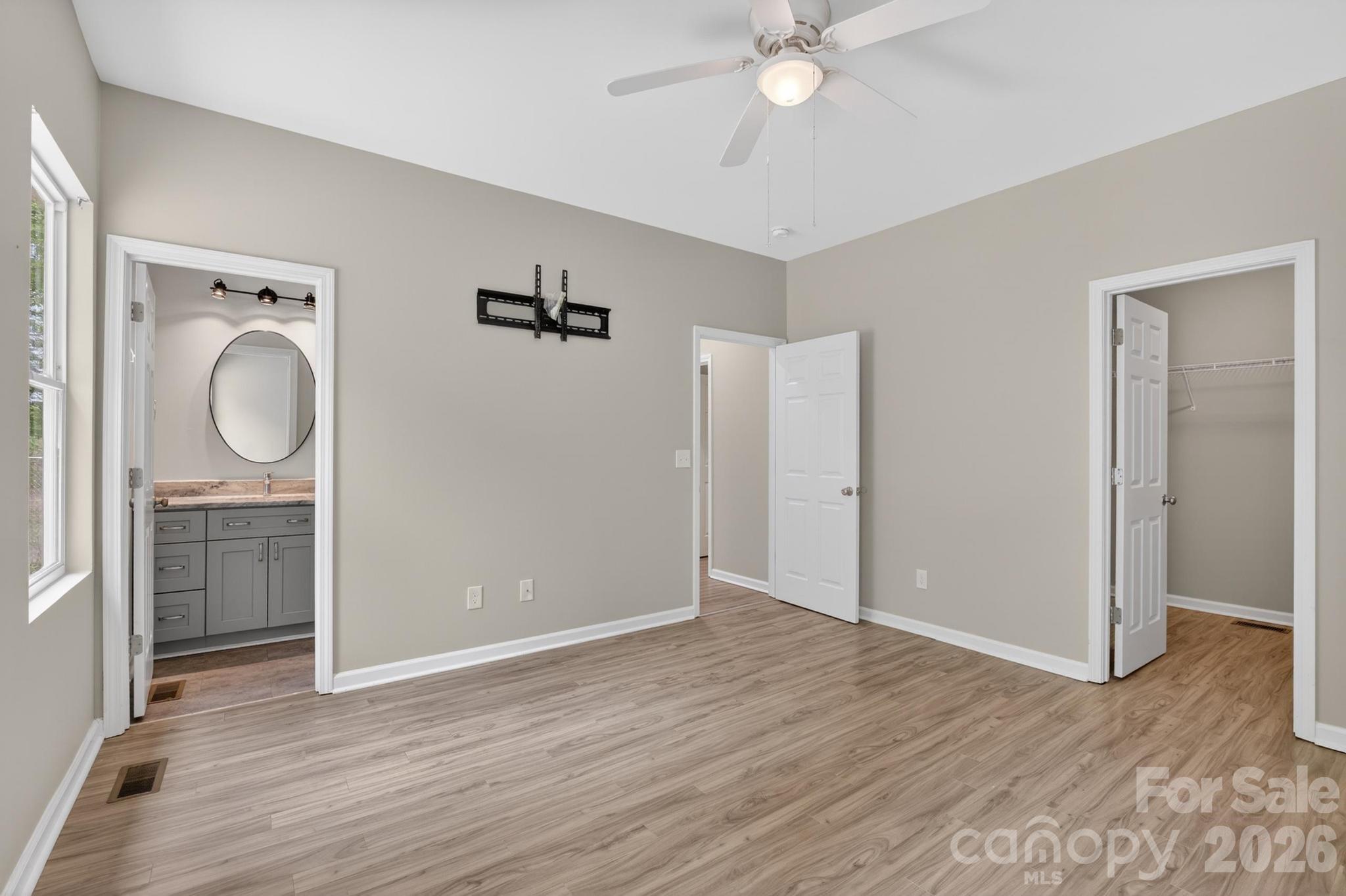 2119 South Road Morganton, NC 28655 - Photo 28 of 47 an empty room with wooden floor mirror and windows
