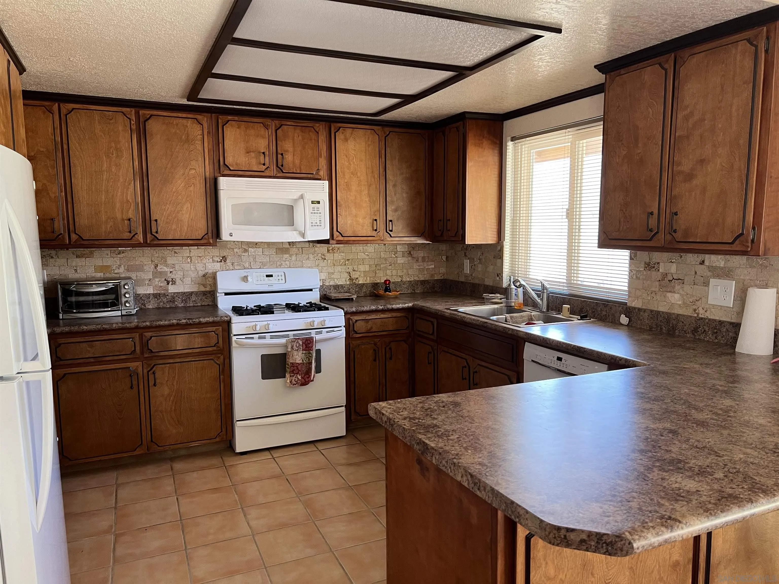 2960 Frying Pan Road Borrego Springs, CA 92004 - Photo 11 of 27 a kitchen with stainless steel appliances granite countertop a sink stove and refrigerator