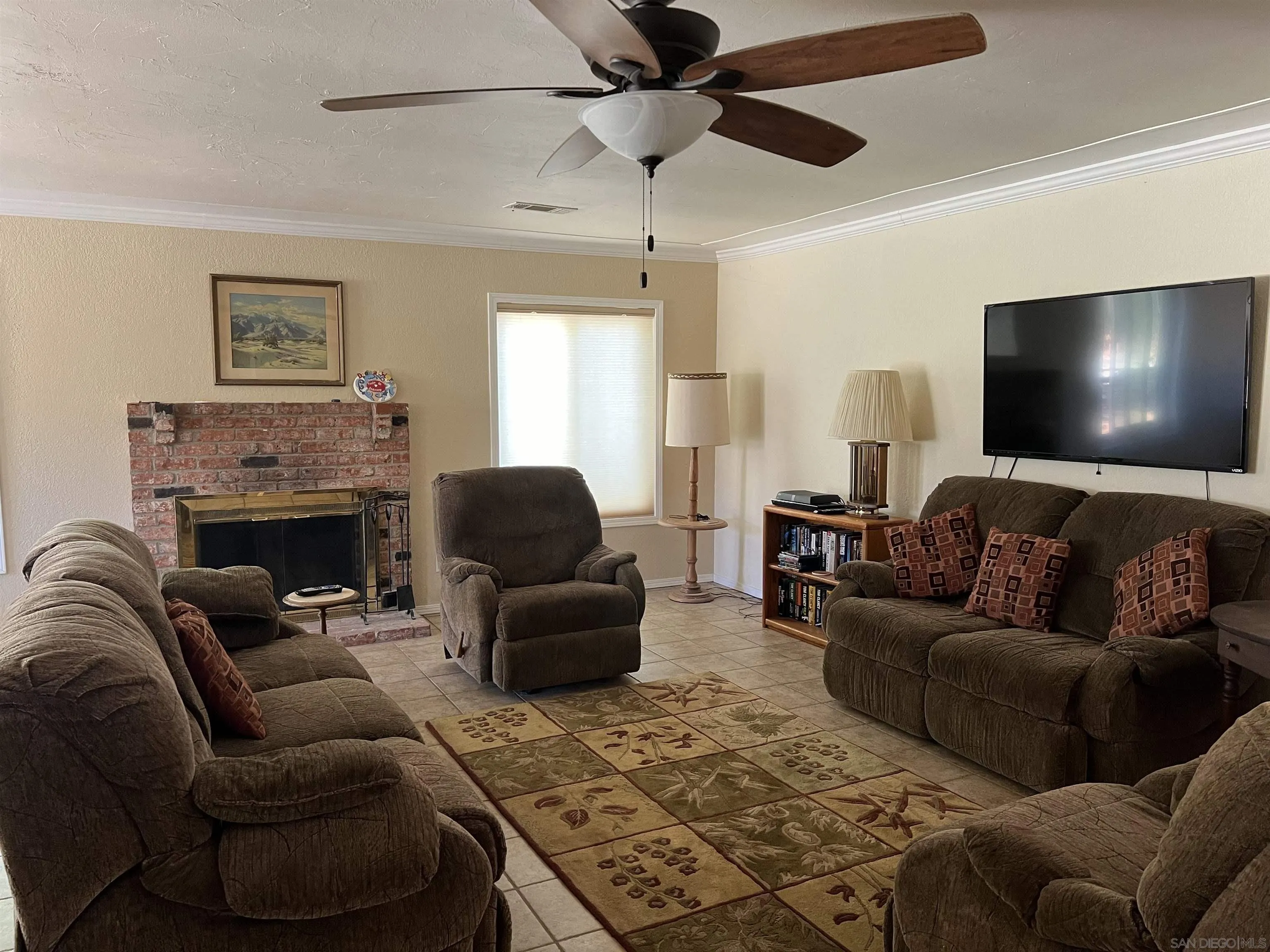 2960 Frying Pan Road Borrego Springs, CA 92004 - Photo 15 of 27 a living room with furniture a flat screen tv and a fireplace