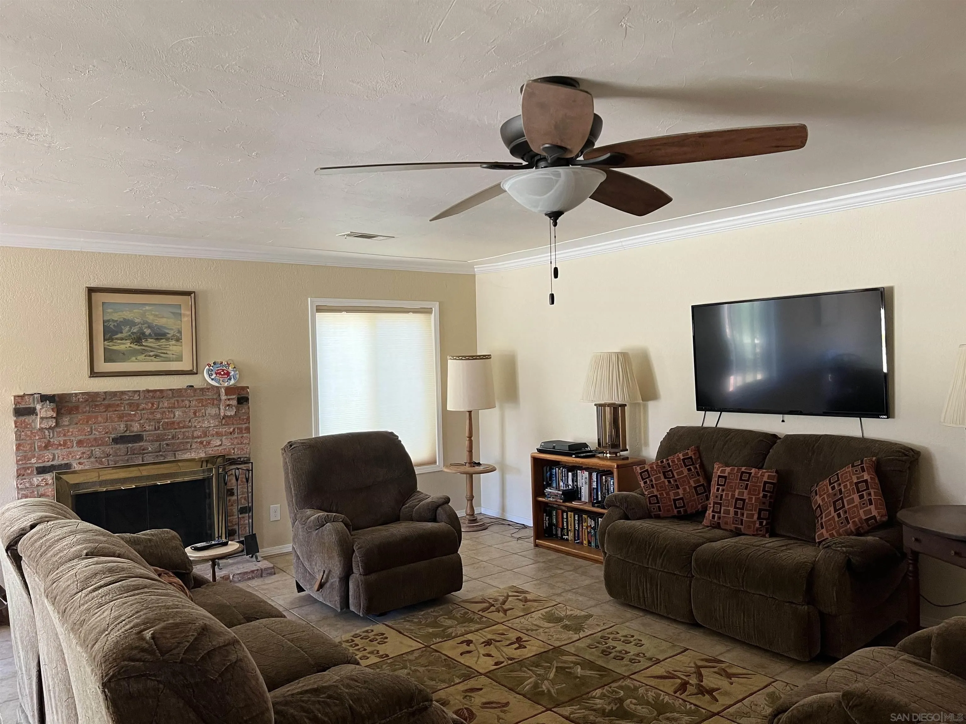 2960 Frying Pan Road Borrego Springs, CA 92004 - Photo 9 of 27 a living room with furniture a fireplace and a flat screen tv