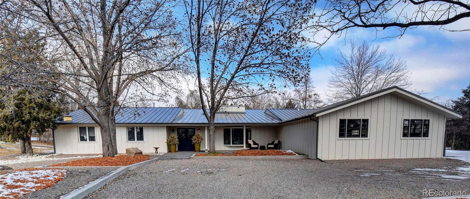 5151 West Wagon Trail Road Littleton, CO 80123 - Photo 1 of 37 a view of a house with a yard and trees