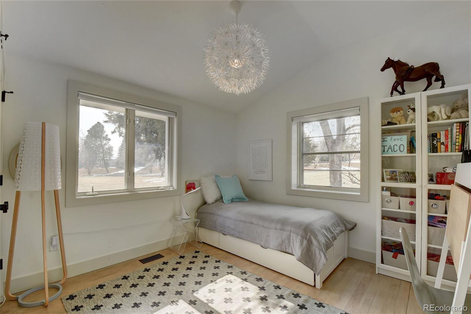 5151 West Wagon Trail Road Littleton, CO 80123 - Photo 29 of 37 a bedroom with a bed and a window